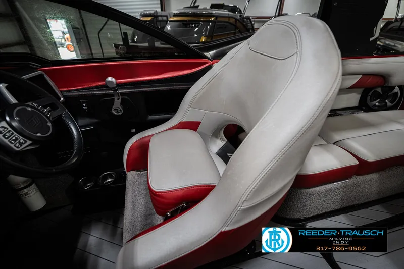 Slide: The Image of 2017 Malibu Wakesetter 25 LSV interior with red and white seating, steering wheel, and controls. - 25