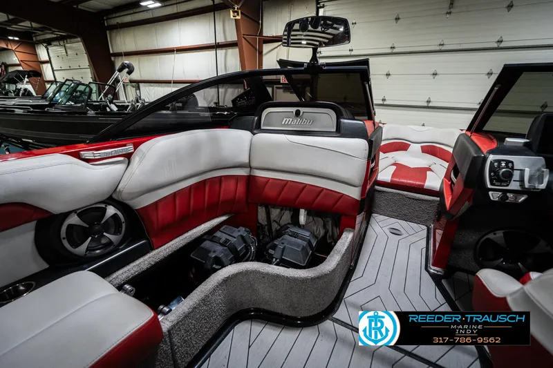 Slide: The Image of 2017 Malibu Wakesetter 25 LSV interior with red and white seating, advanced audio system. - 29