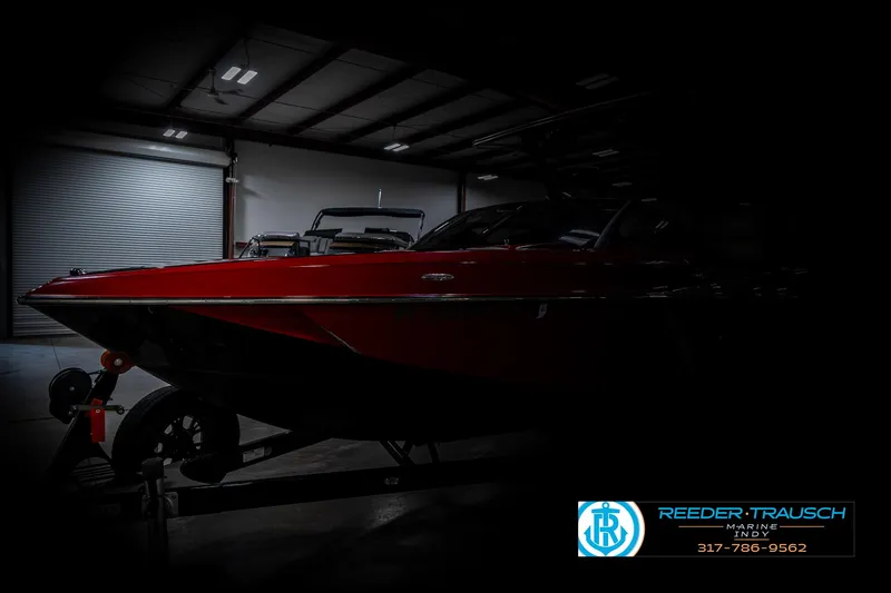 Slide: The Image of 2017 Malibu Wakesetter 25 LSV boat in a dimly lit indoor setting. - 3
