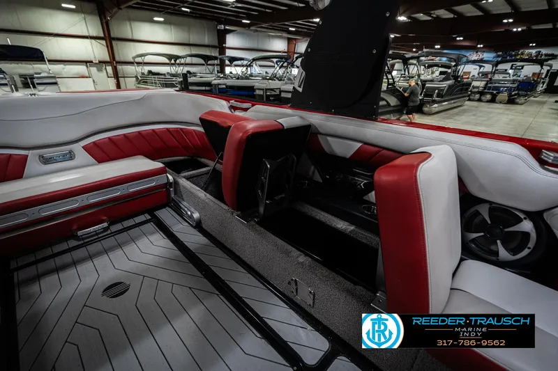 Slide: The Image of 2017 Malibu Wakesetter 25 LSV interior with red and white seating in a showroom. - 32