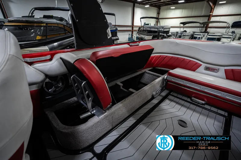 Slide: The Image of 2017 Malibu Wakesetter 25 LSV interior with red and gray seating, open storage compartments. - 34