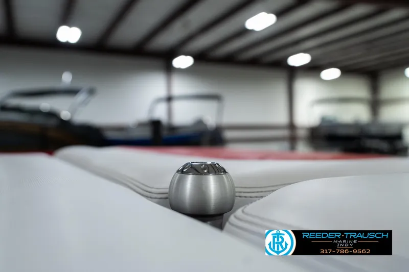 Slide: The Image of 2017 Malibu Wakesetter 25 LSV interior detail in showroom, Reeder-Trausch Marine logo visible. - 42