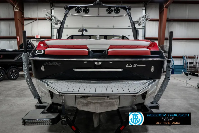 Slide: The Image of 2017 Malibu Wakesetter 25 LSV boat in a showroom, rear view with red seating. - 6