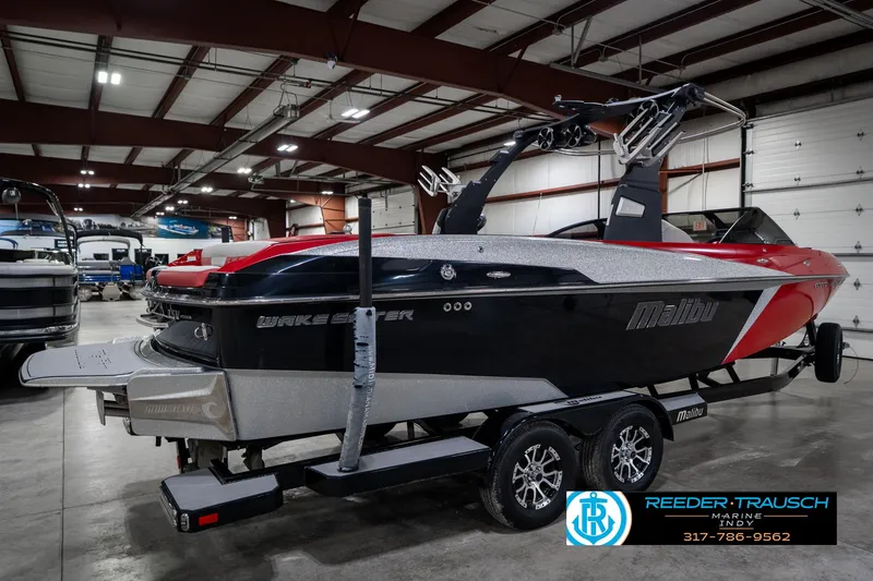 Slide: The Image of 2017 Malibu Wakesetter 25 LSV boat in showroom, featuring sleek design and vibrant colors. - 7