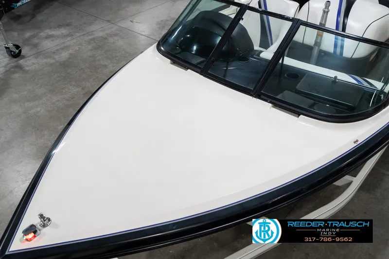 Slide: The Image of 1997 Malibu Response boat with sleek white deck and windshield in showroom. - 10