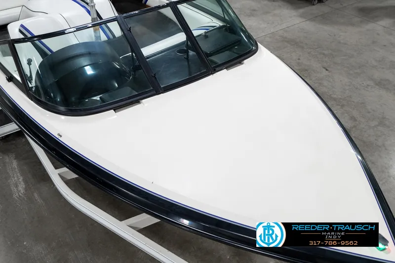 Slide: The Image of 1997 Malibu Response boat, white hull, black trim, in showroom. - 11