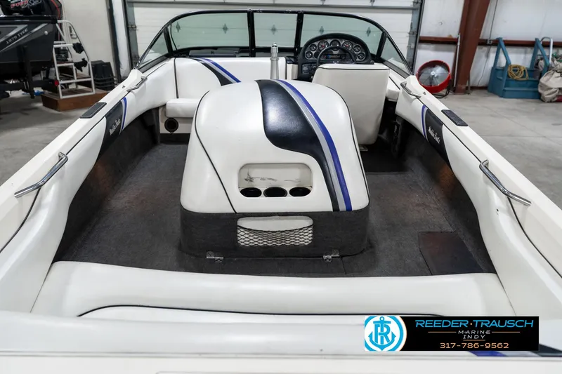 Slide: The Image of 1997 Malibu Response boat interior with white and blue seating, dashboard, and steering wheel. - 14