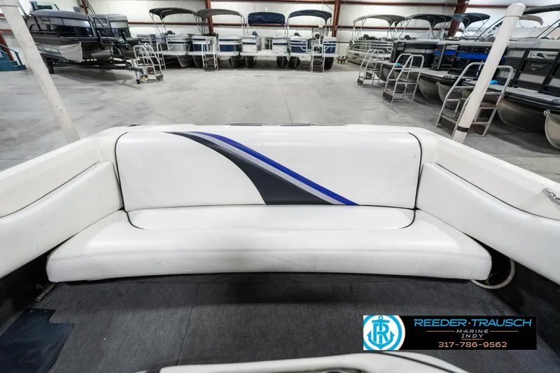 Slide: The Image of 1997 Malibu Response boat interior with white seating in a showroom. - 17