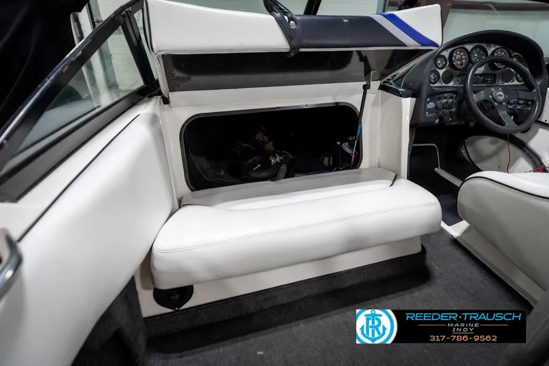 Slide: The Image of 1997 Malibu Response boat interior with white seating and dashboard controls. - 19