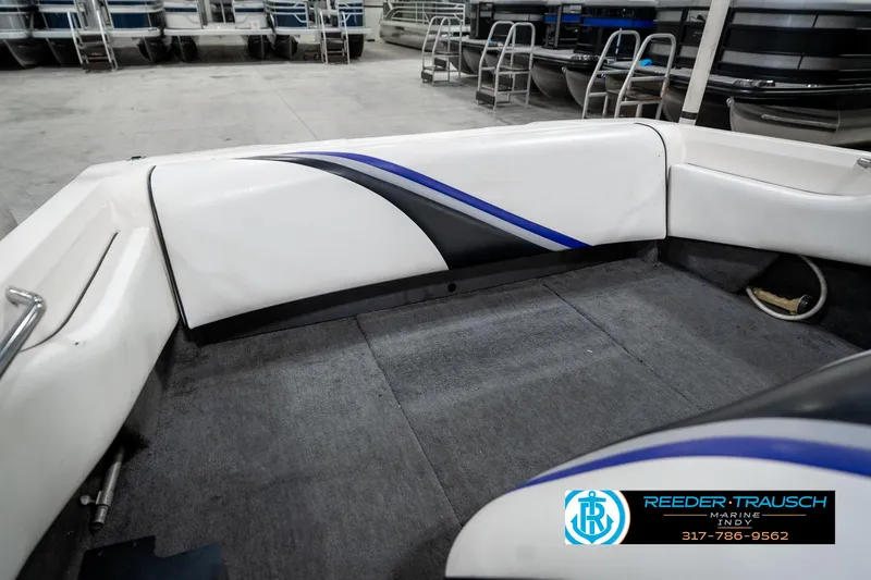 Slide: The Image of 1997 Malibu Response boat interior with white and blue upholstery in a showroom. - 24