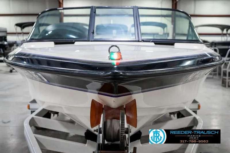 Slide: The Image of 1997 Malibu Response boat on trailer in indoor showroom, Reeder-Trausch Marine logo visible. - 3
