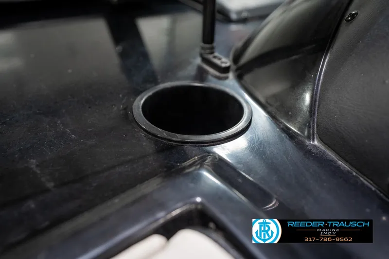 Slide: The Image of Close-up of a 1997 Malibu Response boat dashboard with cup holder. - 36