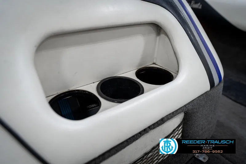Slide: The Image of 1997 Malibu Response boat interior with cup holders and blue stripe design. - 37