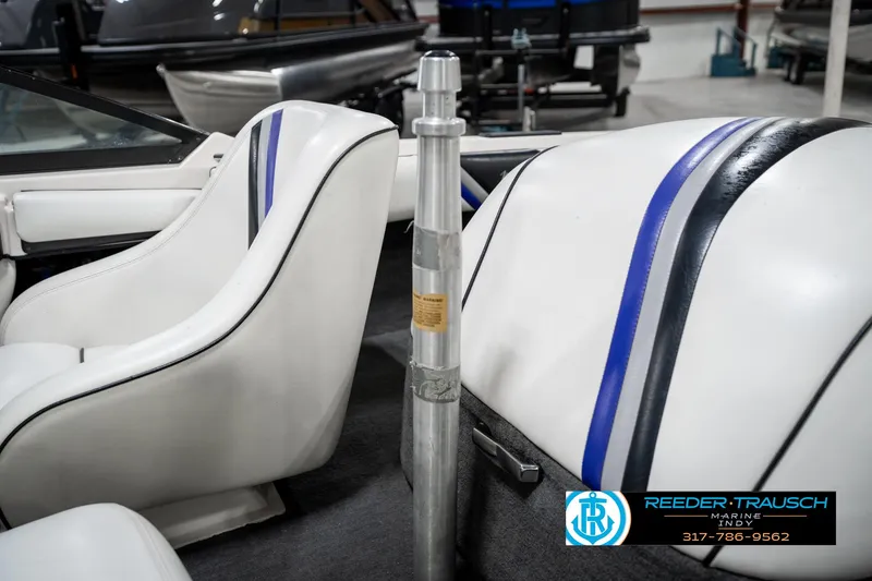 Slide: The Image of 1997 Malibu Response boat interior with white seats and blue accents. - 38