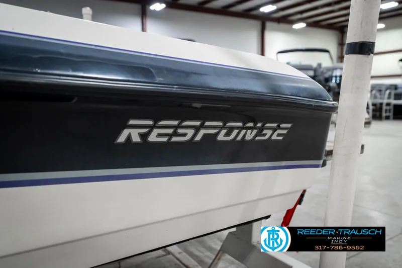Slide: The Image of 1997 Malibu Response boat in showroom, featuring sleek design and branding. - 41