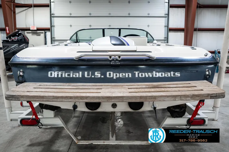 Slide: The Image of 1997 Malibu Response boat labeled "Official U.S. Open Towboats" in a garage setting. - 7