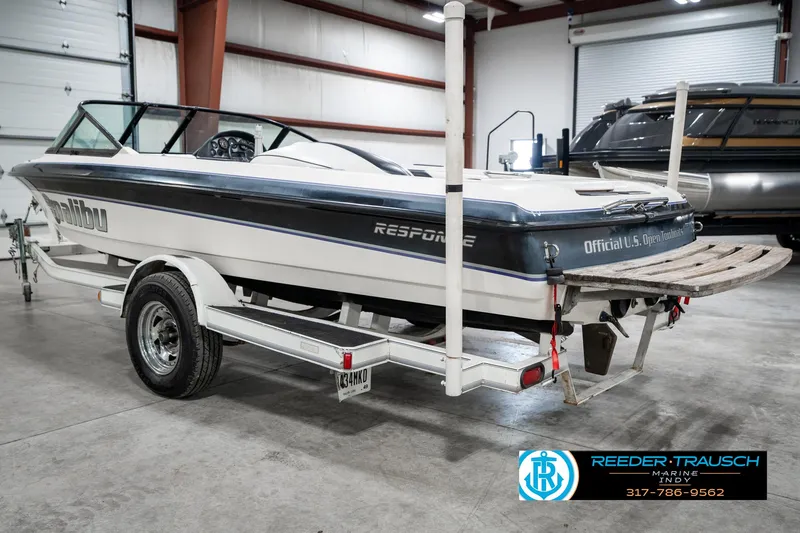 Slide: The Image of 1997 Malibu Response boat on trailer in indoor storage facility. - 8