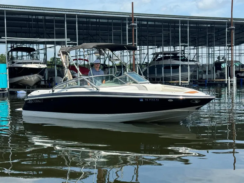 Slide: The Image of 2002 Cobalt 240 boat docked in marina, calm water reflections. - 1