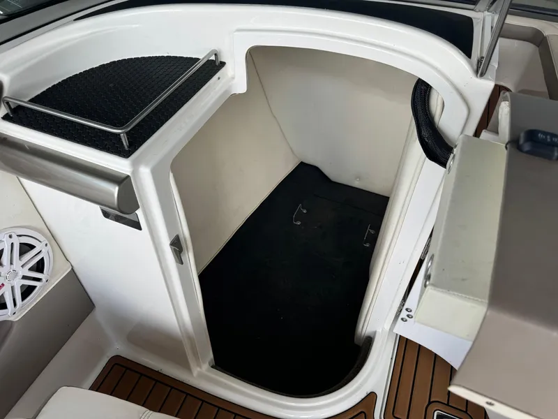 Slide: The Image of 2002 Cobalt 240 boat interior cabin with white and black accents. - 10