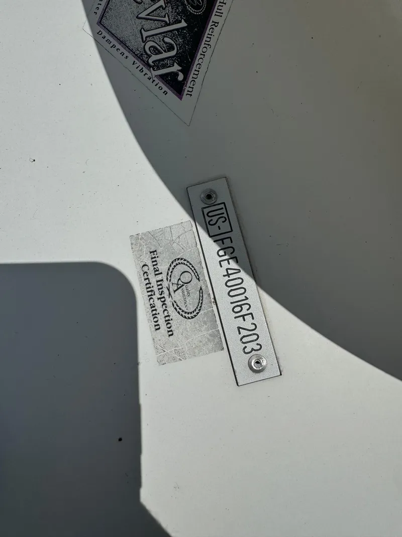 Slide: The Image of Hull identification number and inspection certification on a 2002 Cobalt 240 boat. - 13