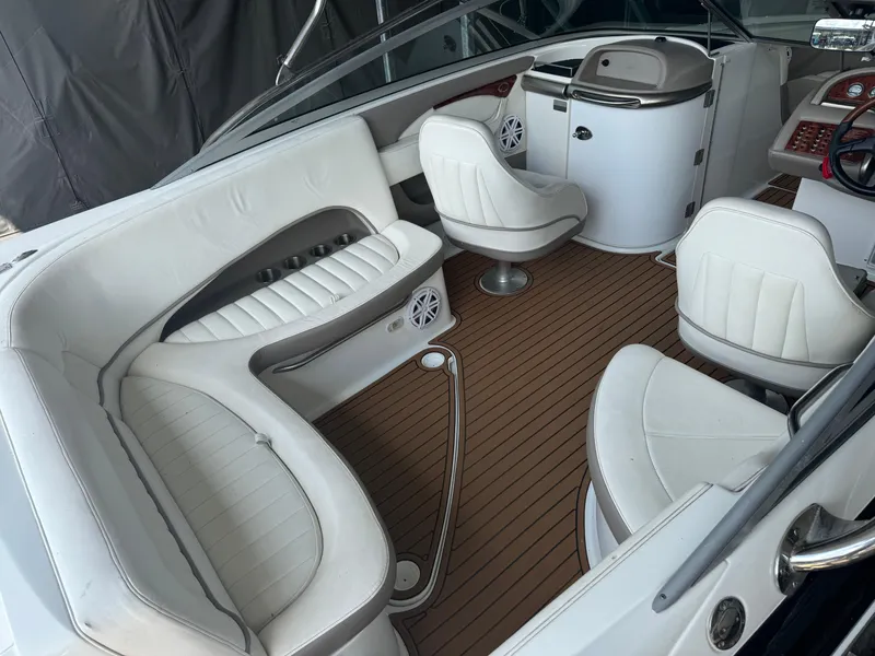 Slide: The Image of Interior of a 2002 Cobalt 240 boat with white seating and wood-style flooring. - 4