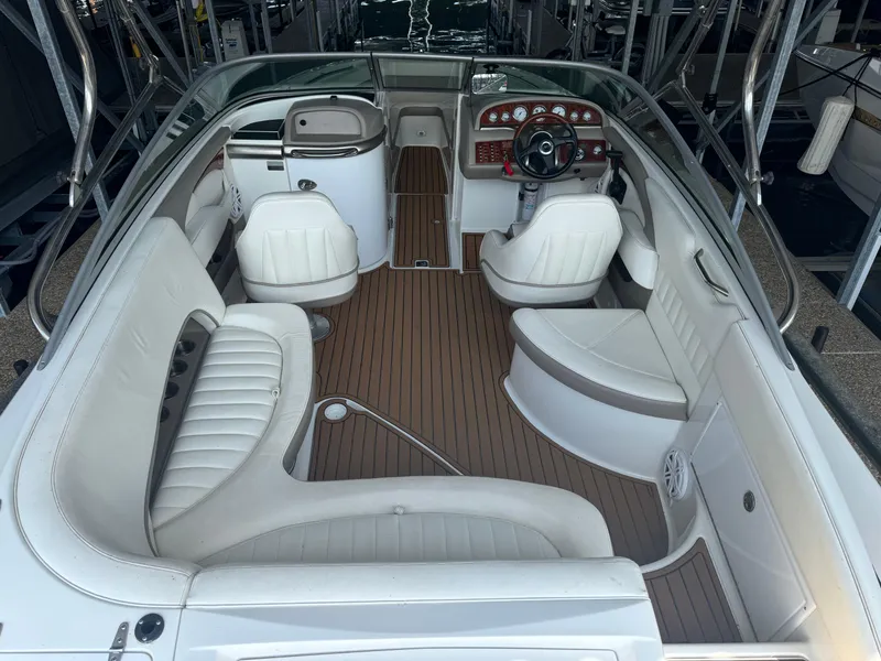 Slide: The Image of 2002 Cobalt 240 boat interior with white seating and wood-style flooring. - 5