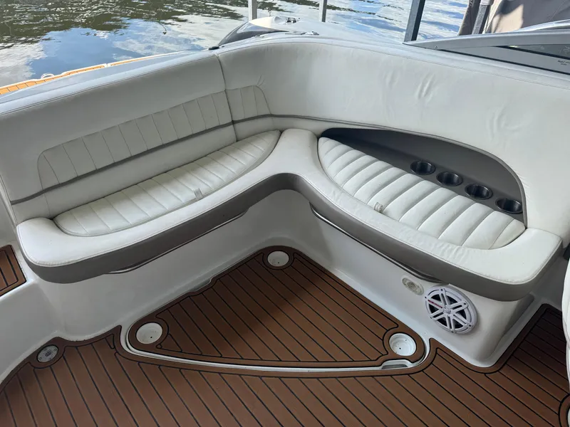 Slide: The Image of Interior of a 2002 Cobalt 240 boat with white seating and wood-like flooring. - 6