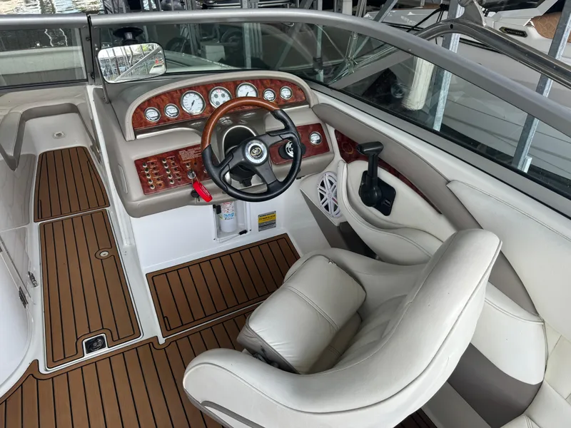 Slide: The Image of Interior of a 2002 Cobalt 240 boat with wood accents and leather seating. - 7