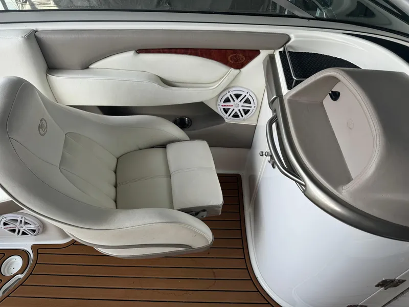 Slide: The Image of Luxurious interior of a 2002 Cobalt 240 boat with white seating and wood accents. - 9