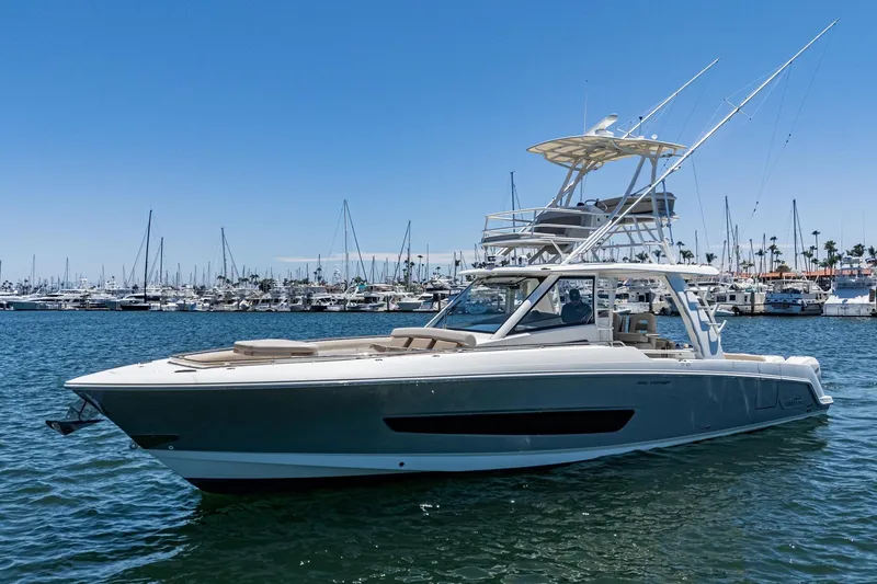 The Image of 2017 Boston Whaler 42 OUTRAGE boat on water, marina background, clear sky. - 1