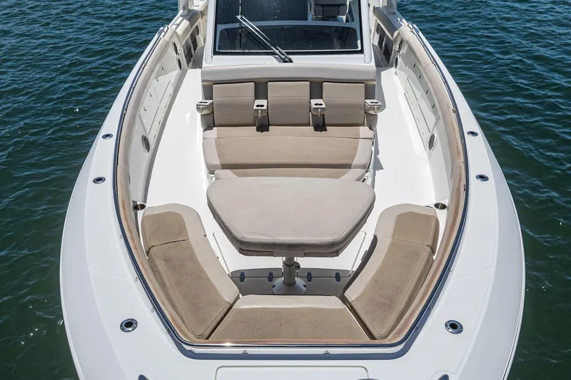 Slide: The Image of 2017 Boston Whaler 42 OUTRAGE boat with spacious seating and table on calm water. - 17