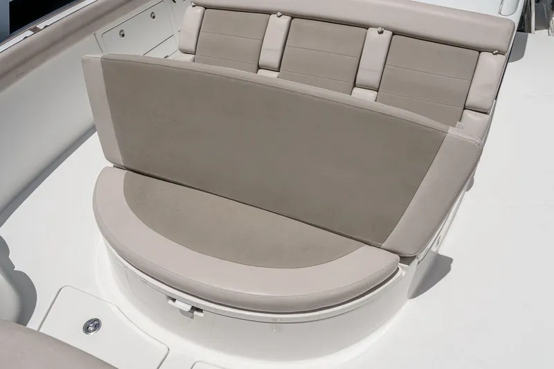 Slide: The Image of Luxurious seating on 2017 Boston Whaler 42 OUTRAGE boat, featuring beige cushions. - 21
