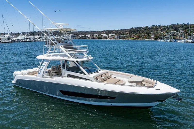 Slide: The Image of 2017 Boston Whaler 42 OUTRAGE boat on calm water, featuring sleek design and spacious deck. - 3