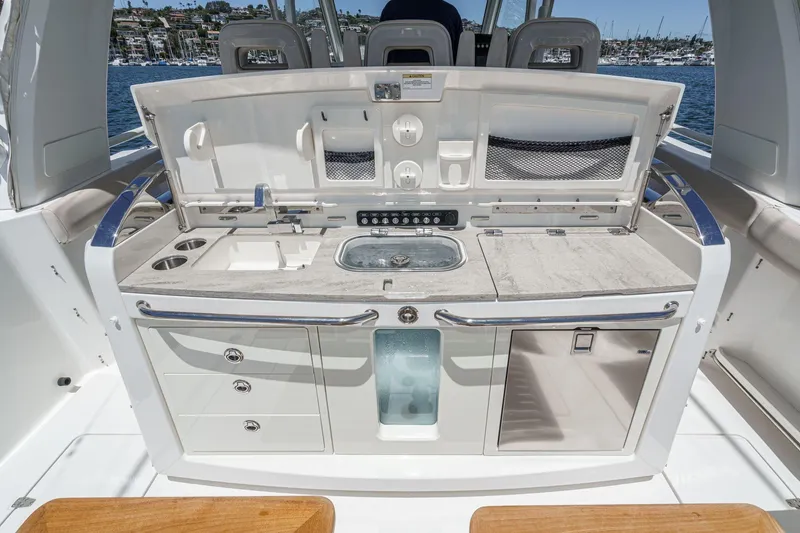 Slide: The Image of 2017 Boston Whaler 42 OUTRAGE boat kitchen with sink, storage, and countertop. - 31