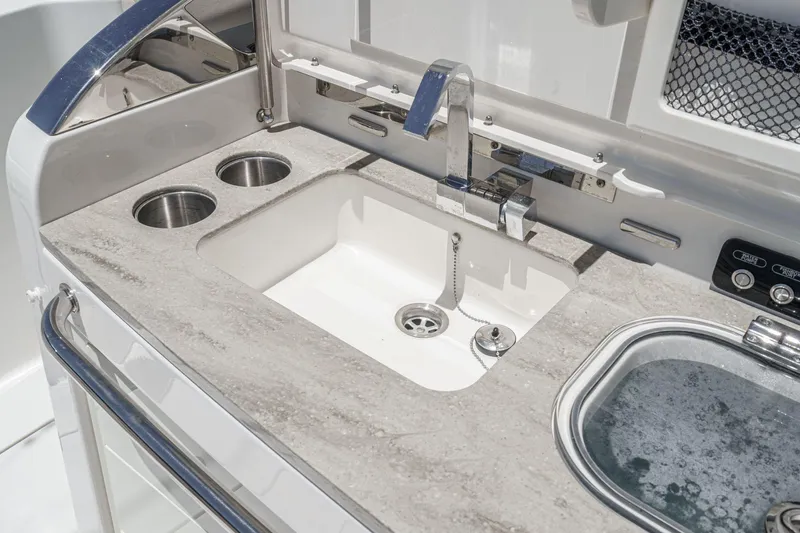 Slide: The Image of 2017 Boston Whaler 42 OUTRAGE boat sink with faucet and cup holders. - 32