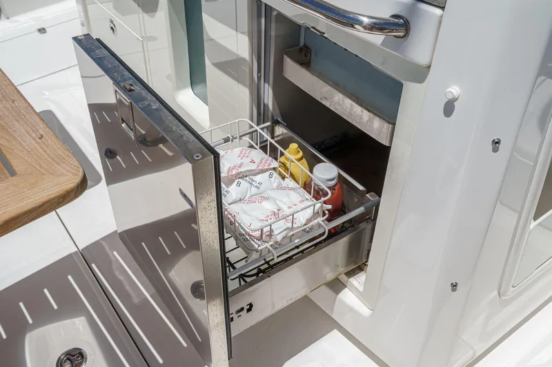 Slide: The Image of Open drawer on 2017 Boston Whaler 42 OUTRAGE boat with condiments and packaged food. - 35