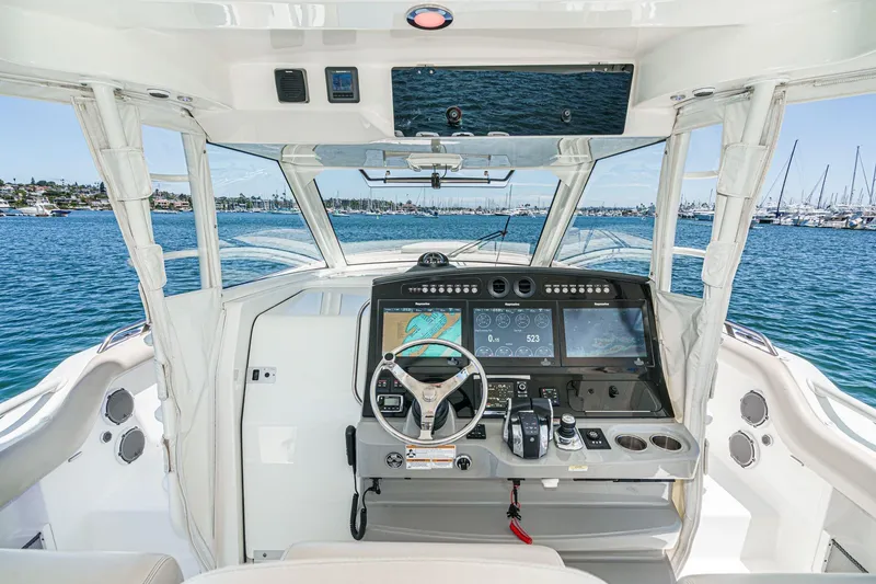 Slide: The Image of 2017 Boston Whaler 42 OUTRAGE helm with advanced navigation system, docked in a marina. - 37