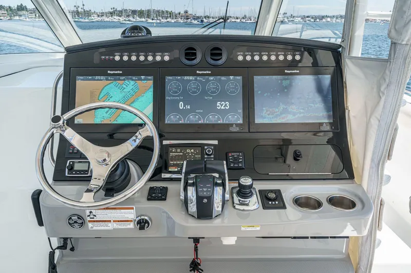 Slide: The Image of Control panel of a 2017 Boston Whaler 42 OUTRAGE with navigation screens and steering wheel. - 38