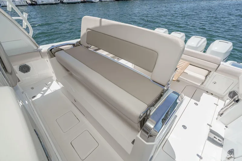 Slide: The Image of 2017 Boston Whaler 42 OUTRAGE boat interior with cushioned seating and ocean view. - 47