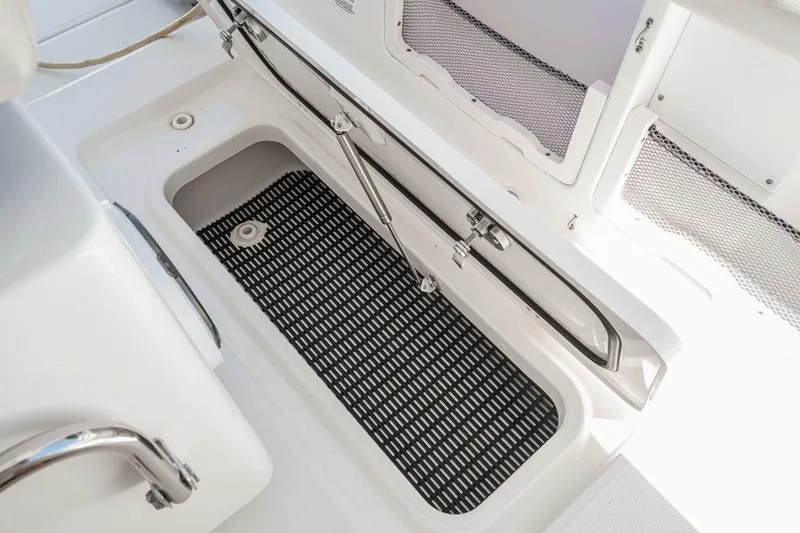 Slide: The Image of Open storage compartment on 2017 Boston Whaler 42 OUTRAGE boat with black mat. - 51