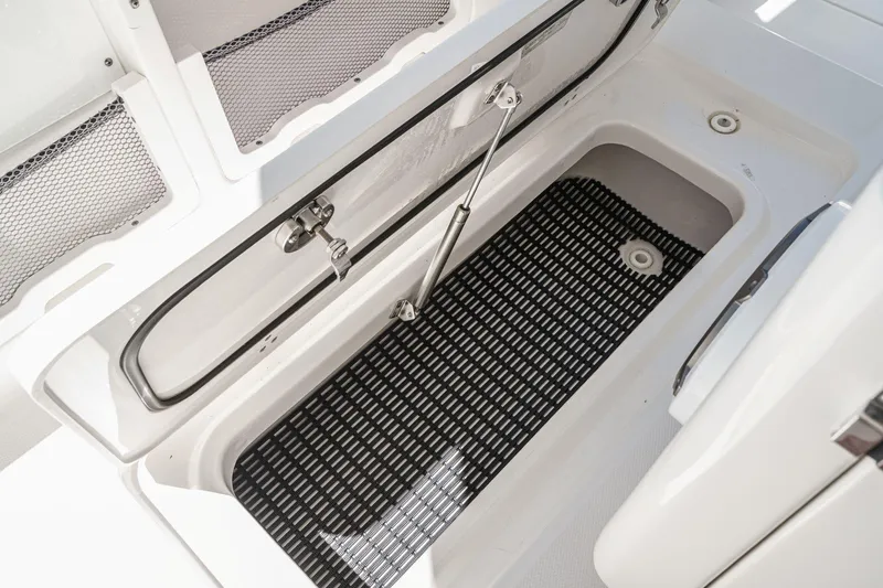 Slide: The Image of Storage compartment of 2017 Boston Whaler 42 OUTRAGE boat with open hatch and black mat. - 52