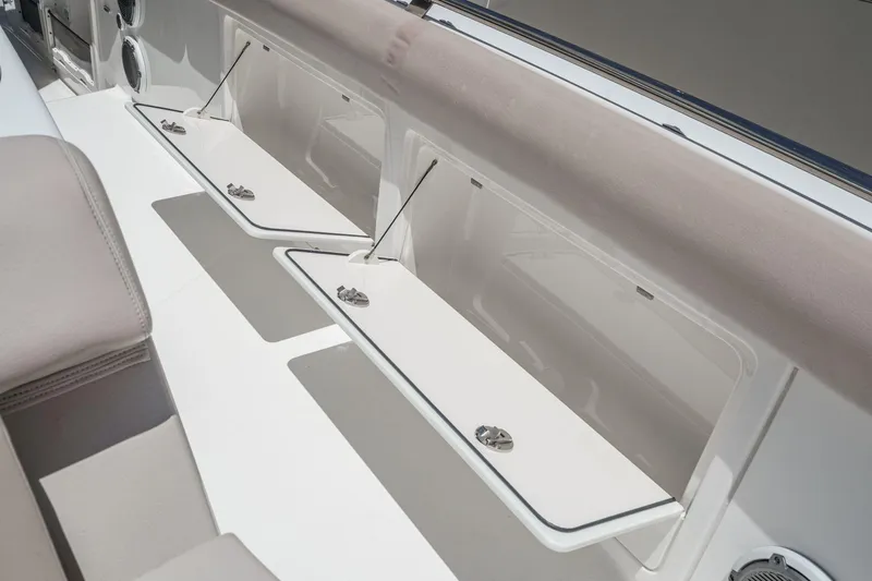Slide: The Image of 2017 Boston Whaler 42 OUTRAGE boat storage compartments with cushioned seating. - 53