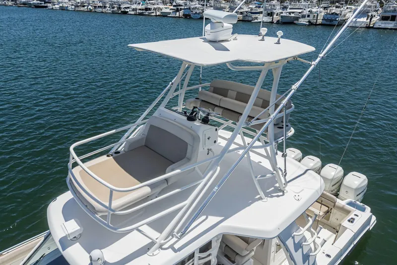 Slide: The Image of 2017 Boston Whaler 42 OUTRAGE boat with upper deck seating, docked in marina. - 55