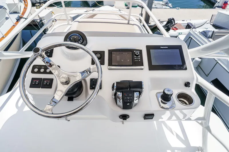 Slide: The Image of Helm of 2017 Boston Whaler 42 OUTRAGE with advanced navigation controls and steering wheel. - 56
