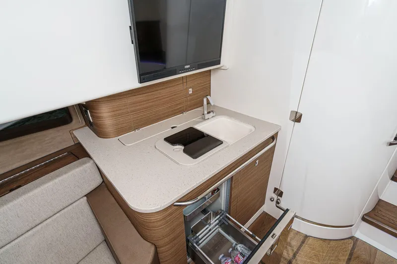 Slide: The Image of 2017 Boston Whaler 42 OUTRAGE interior with kitchenette, sink, and open drawer. - 63