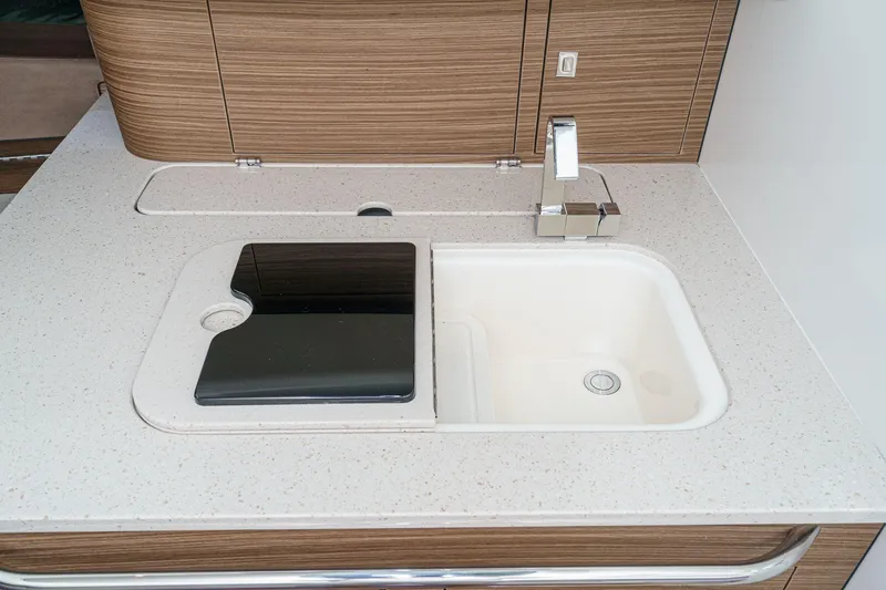 Slide: The Image of Modern kitchen sink on 2017 Boston Whaler 42 OUTRAGE yacht, featuring sleek faucet and countertop. - 64