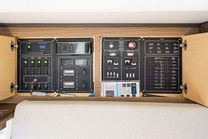 Slide: The Image of Control panel of a 2017 Boston Whaler 42 OUTRAGE boat, featuring switches and gauges. - 68