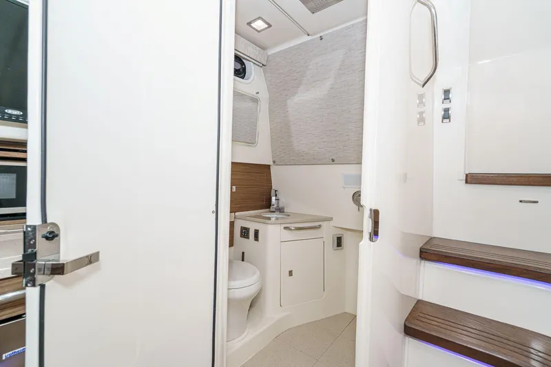 Slide: The Image of Interior of 2017 Boston Whaler 42 OUTRAGE, featuring a compact bathroom with modern amenities. - 73