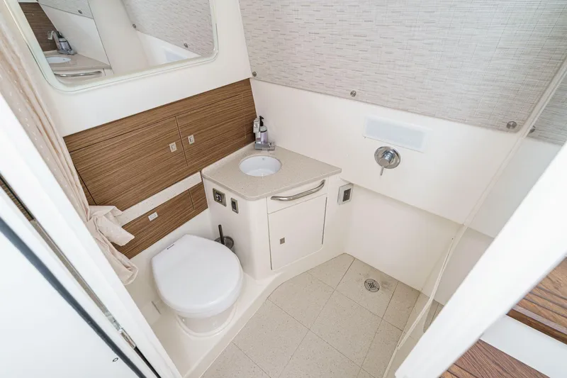 Slide: The Image of Luxurious bathroom in 2017 Boston Whaler 42 OUTRAGE boat, featuring modern fixtures and wood accents. - 74