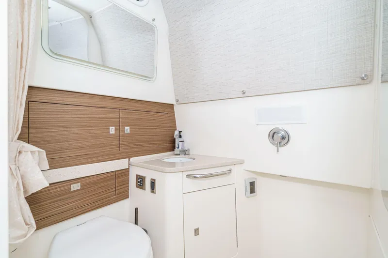 Slide: The Image of 2017 Boston Whaler 42 OUTRAGE bathroom with modern fixtures and wood accents. - 75